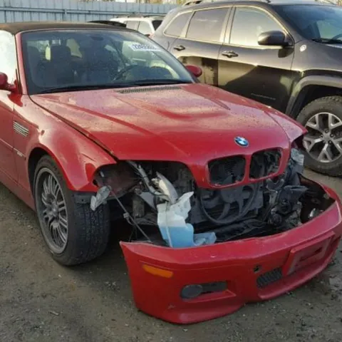 Red BMW M3 convertible with the front bumper removed after a front-end impact
