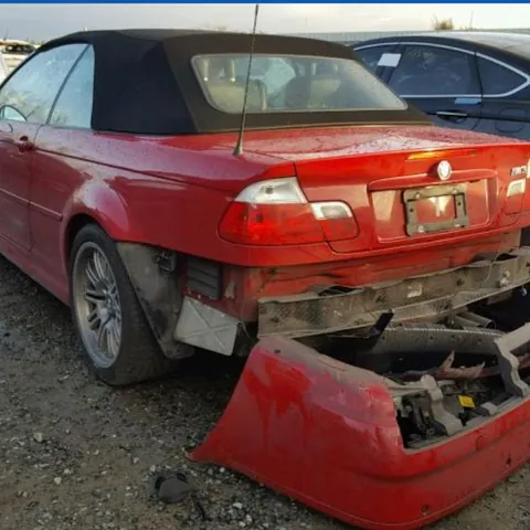 Red BMW M3 convertible from the rear with the boot open and the rear bumper off