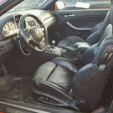 BMW M3 interior — black leather seats, M steering wheel and a manual gear lever