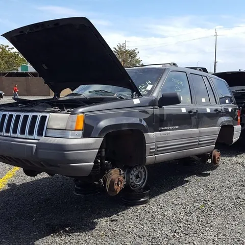 Older Jeep Grand Cherokee stripped to the hubs with the bonnet raised