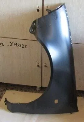 A front wing panel in primer, stored indoors ready to fit
